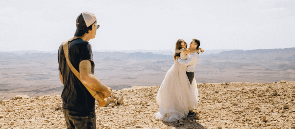 A photographer shooting a couple at a wedding