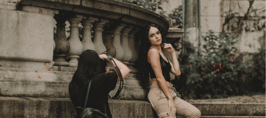 A photographer taking a beautiful photograph of a woman