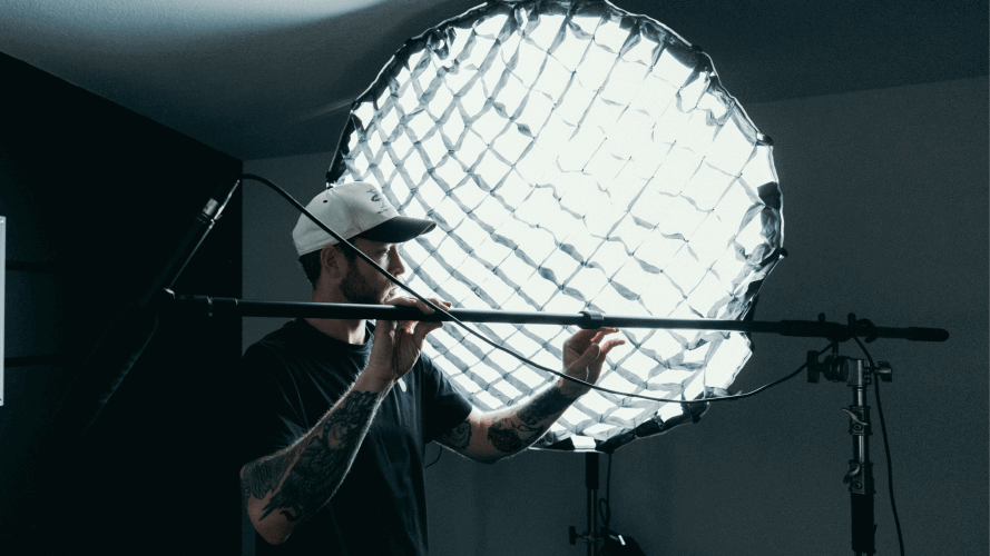 A photographer setting up lighting for a shoot