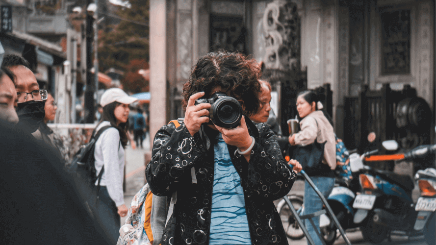 A photographer taking photos in public