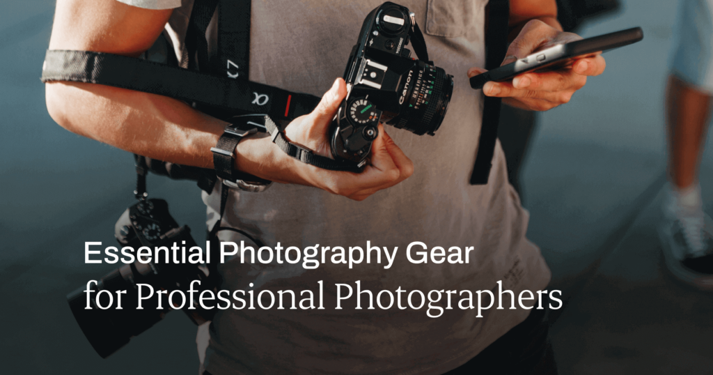 Person holding a phone and a camera, with another camera slung over their shoulder. Title text on the image: Essential Photography Gear for Professional Photographers