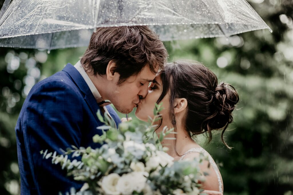 wedding photo in the rain with umbrella