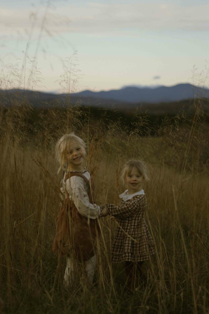 Stand side by side and hold hands like best friends.