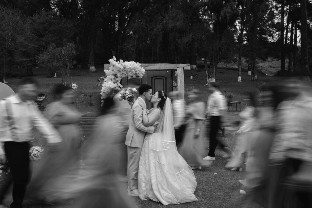blurred people in the background black and white wedding photography