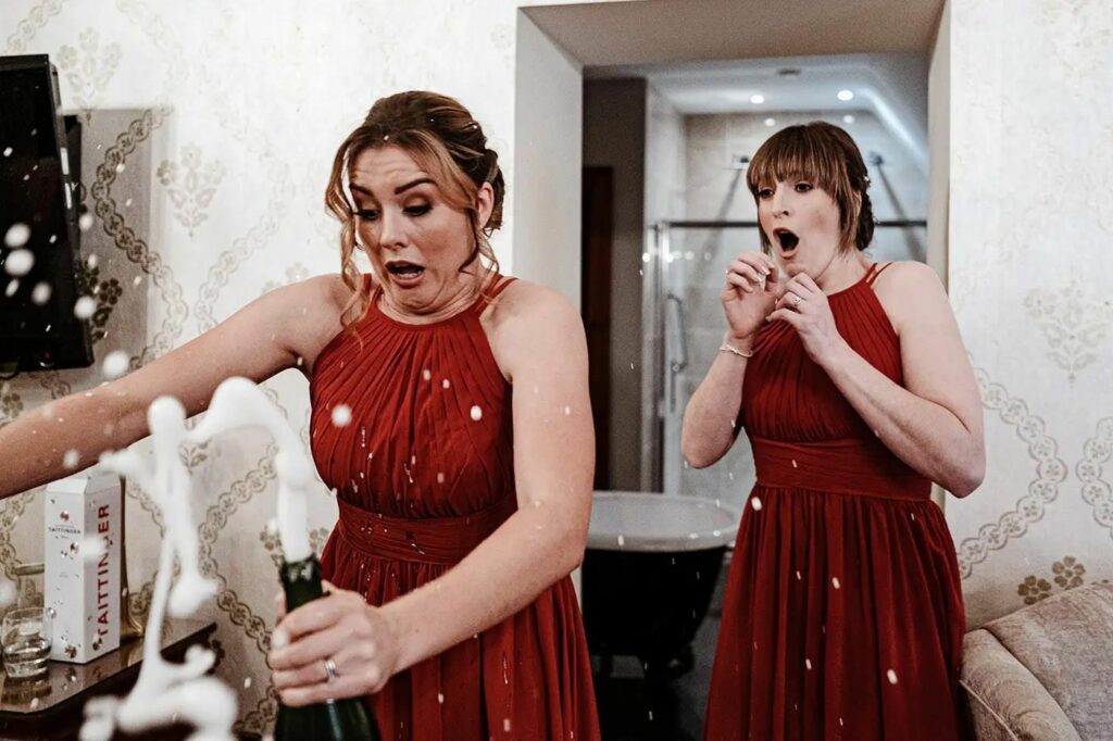 capturing documentary wedding photography candid shot of drink spilling when opened